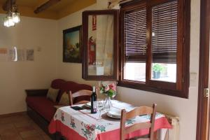 Habitación con mesa, sofá, mesa y sillas. en Apartamentos Rurales Rosendo: La Orquídea, en Capileira