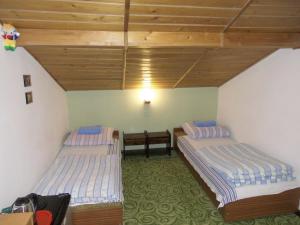a room with two beds and a table at Gościniec Nad Jarem in Gołdap