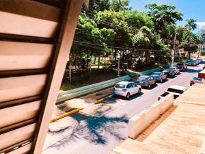 a row of cars parked in a parking lot at Hotel São Pedro in São Pedro