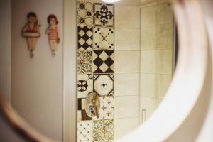 a bathroom with a shower with a tiled wall at Casa Luna in Santa Maria di Castellabate
