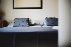 a bed with blue sheets and pillows in a room at Casa Luna in Santa Maria di Castellabate
