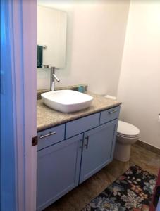 a bathroom with a sink and a toilet at Aquamarine Suites in Kodiak