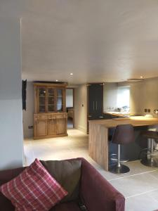 a kitchen with a couch and a table in a room at Coed Canol Farm in Abergavenny