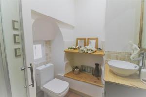 a bathroom with a white toilet and a sink at La Maison du Canal - Canal Studio in Homps
