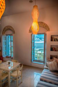 a living room with a table and a window at Aretanassa Hotel in Halki