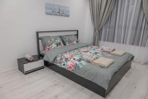 a bedroom with a bed with pillows on it at Vip Luxury APARTMENT in Burgas City