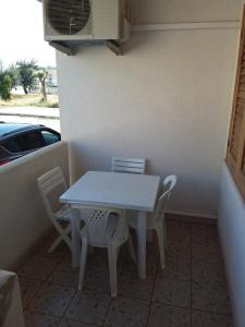 a white table and chairs sitting on a patio at fabrizio e caterina in San Vito lo Capo