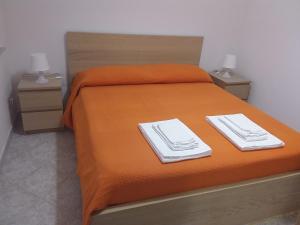 a bed with two plates and towels on it at fabrizio e caterina in San Vito lo Capo