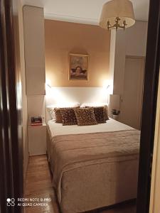 a bedroom with a large bed with lights on it at Broadway apartament in Šiauliai