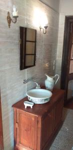 a bathroom with a sink and a mirror at La Casa de Adobe Natural y Más in Bulnes