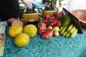 a table with a bunch of fruits and vegetables on it at JO's Farmstay-charming holiday farm close to famous Muri Beach in Rarotonga