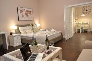 a bedroom with a bed and a desk with a laptop at City Centre Dream place in Zagreb