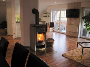 a living room with a wood stove in it at Ferien- bzw. Zeitwohnen Burglengenfeld in Burglengenfeld