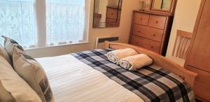 a bedroom with a bed with two towels on it at 127 on Atholl in Pitlochry