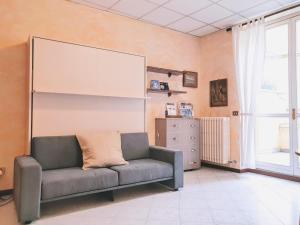 a living room with a couch and a large screen at Il Pontile - Historic Center by villavistalago it in Bellano