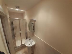 a bathroom with a sink and a shower at Beachside Holiday Home in Portrush