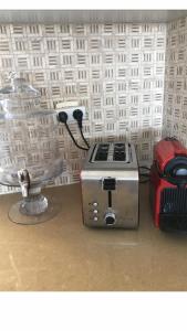 a toaster sitting on a counter next to a blender at CHAMBRES D’HÔTES EILAT in Eilat