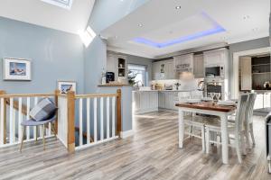 a kitchen and dining room with a table and chairs at Mollys Barn in Loughgall