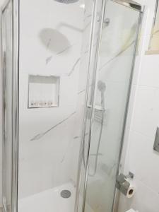 a shower with a glass door in a bathroom at Beco's House - Suits in Ílhavo