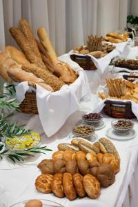 a table topped with lots of different types of bread at Achillion Palace in Rethymno
