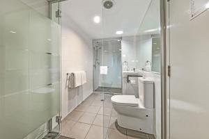 a bathroom with a shower and a toilet and a sink at The Capitol Apartments in Brisbane