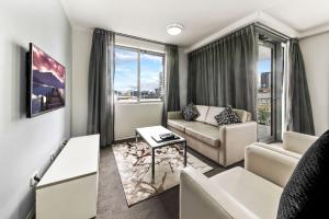 a living room with a couch and a table at The Capitol Apartments in Brisbane