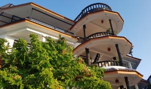 a building with balconies on the side of it at La Capannina Hotel Patong in Patong Beach