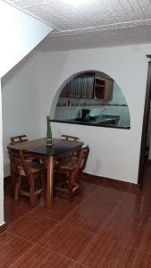 a dining room with a table and chairs and a kitchen at apartamento tejares de Salento in Salento