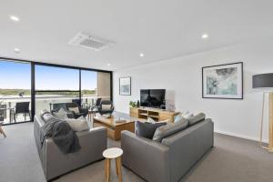 a living room with two couches and a television at Stunning Main Beach Location- Anglesea in Anglesea