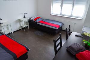 Sala de estar con 2 camas y mesa en Zimmervermietung Dietzenbach en Dietzenbach