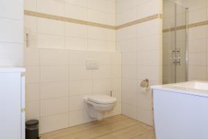 a white bathroom with a toilet and a sink at Zimmervermietung Dietzenbach in Dietzenbach