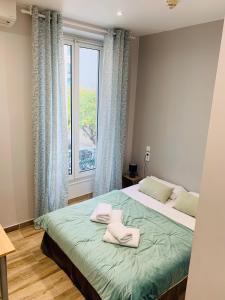a bedroom with a bed and a window at Hotel le Nice Etoile in Nice