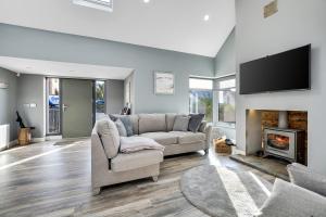 a living room with a couch and a fireplace at Mollys Barn in Loughgall