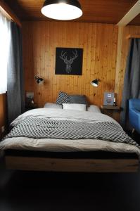 a bedroom with a large bed with wooden walls at Chalet Bietschhorn Rosswald in Termen