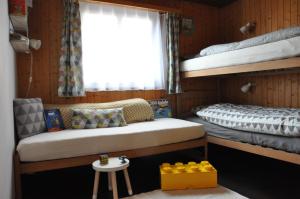 a room with two bunk beds and a table at Chalet Bietschhorn Rosswald in Termen