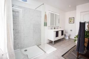 a white bathroom with a shower and a sink at Carcassonne Townhouse in Carcassonne +36 photos