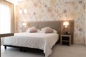 מיטה או מיטות בחדר ב-Hotel Pontemare