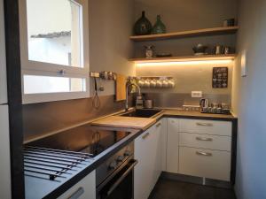 a small kitchen with a sink and a stove at The View Of Sangiorgio in Florence