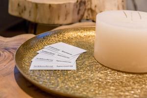a plate with two cards on a table with a candle at Schlossberg - Apartment in Graz