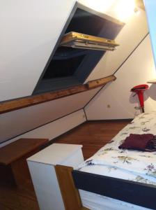 a attic room with a bed in a room at Un studio à louer ds un endroit calme près de la ville de Dinant in Dinant