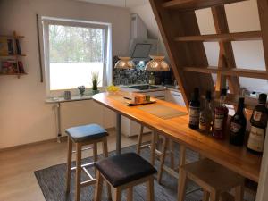 a kitchen with a wooden counter with bottles of wine at Attraktives Landhaus Nähe Bremen in Stuhr