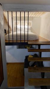 a loft bed in a room with a bed at Charmant studio vieil Antibes in Antibes