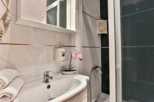 a white bathroom with a sink and a shower at Apartmani Luka - Vila Brzulovic in Rafailovici +51 photos