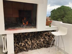 a fire pit with a pile of fire wood at Villa Dragi in Klek