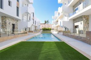 a courtyard with a swimming pool in a building at Luxury Appartement Los Arenales Del Sol, Near Beach, Large Solarium, Full Equipement in Arenales del Sol