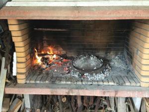 a brick oven with a fire inside of it at Apartments "Villa Cupic"-Vodice in Vodice