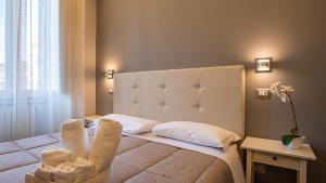 Postel nebo postele na pokoji v ubytování Borghese Executive Suite