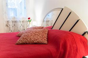 a red bed with a red blanket and a mirror at CasaMisa Ca' Amaranta in Venice