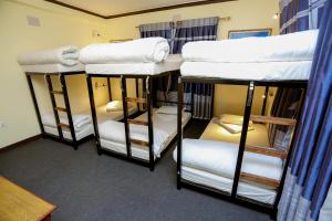 Una cama o camas en una habitación de Pokhara Backpackers Hostel