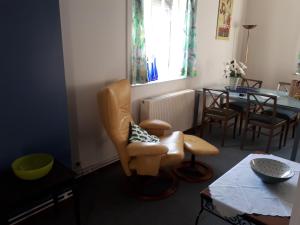 a living room with a chair and a table at Apartment Descamps in Blankenberge